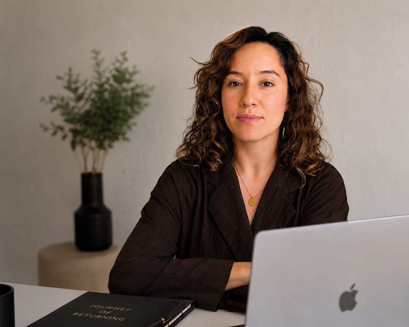 Ashley Leon at her desk with her laptop